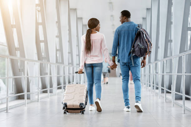 istock Romantic Black Couple Walking With Suitcases In Airport Terminal, Holding Hands 1264246830