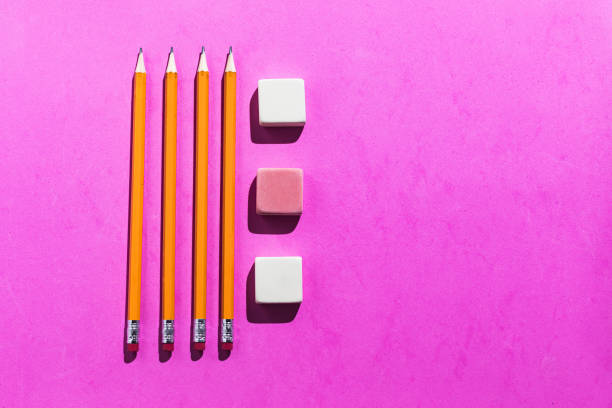 istock Four orange pencils and three rubber erasers from above on pink background. Office and school concept 1264246870