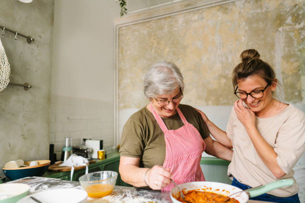 istock Mother and daughter making pasta in the kitchen 1264248361