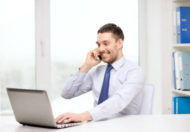 istock businessman with laptop and smartphone at office 1264248681