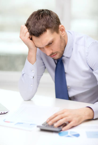 istock stressed businessman with laptop and documents 1264249223