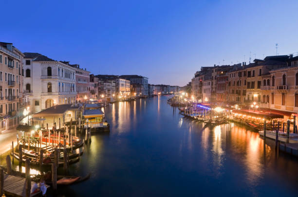 View from the Rialto Bridge onto the Grand Canal in Venice, Italy in the evening.