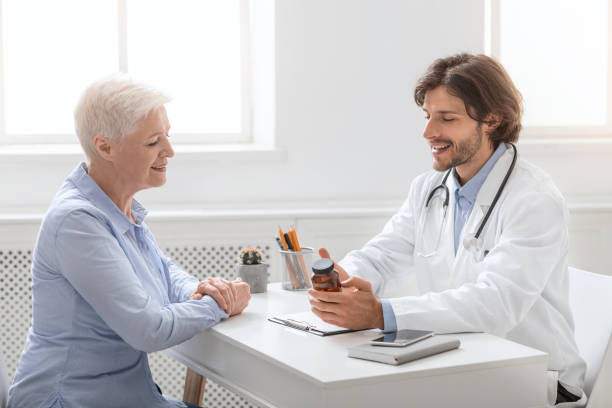 istock Professional doctor telling pills schedule to senior patient 1264253979