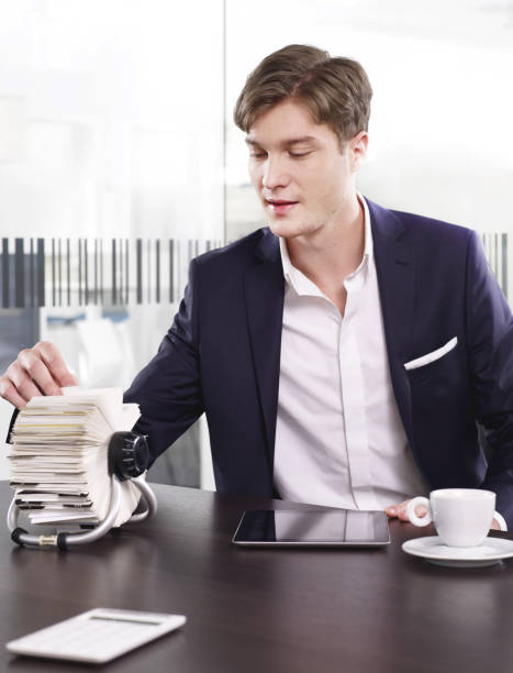 businessman with rotary card file - rotary card file imagens e fotografias de stock