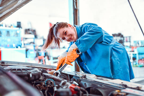 istock Smiling Female Mechanic Tightening Car Engine Stabilizers 1264257971