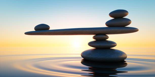 Seesaw Stack of Stones Stack of stones in calm water with seesaw in the evening sun stability stock pictures, royalty-free photos & images