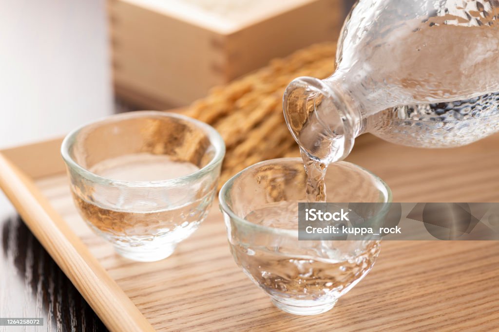 Cold sake with rice and ear of rice on the table Saki Stock Photo