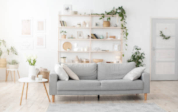 istock Blurred Stylish Living Room Interior Background With Sofa, Shelves And Coffee Table 1264267312