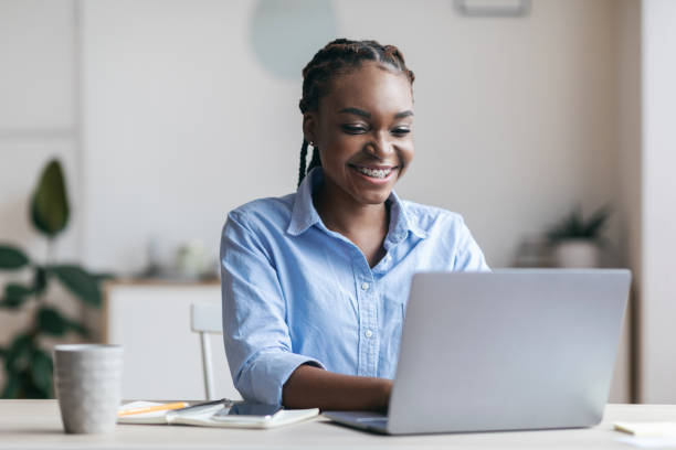 istock Young Black Secretary Working On Laptop In Modern Office, Typing On Keyboard 1264267319