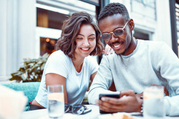 istock Mixed Couple Enjoying Refreshment And Online Shopping 1264268587