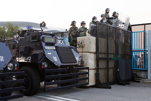 Riot police and armoured police vehicle at Wanchai district of Hong Kong.