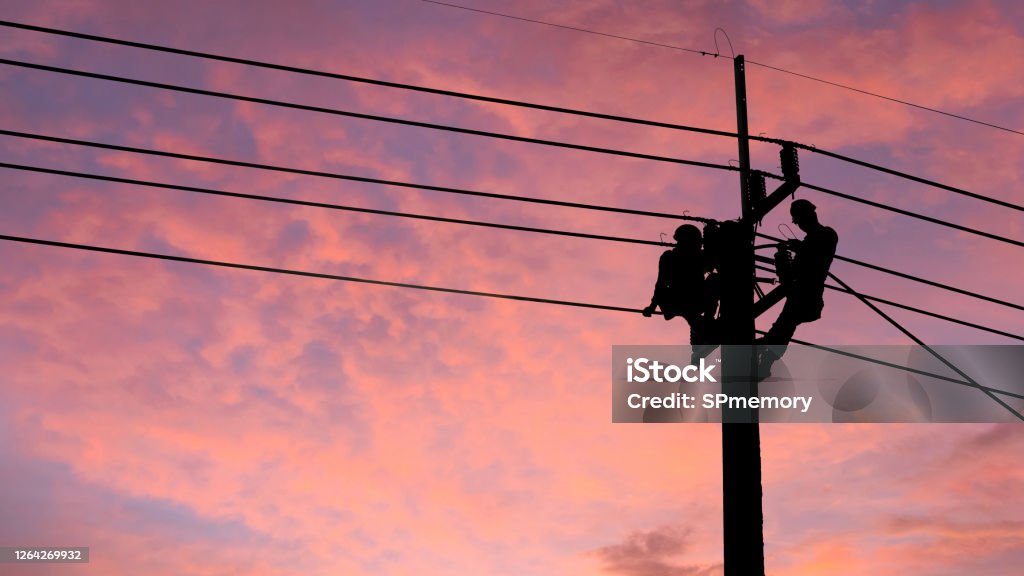 Electrician worker climbing electric power pole to repair the damaged power cable line problems after the storm. Power line support,Technology maintenance and development industry concept Power Line Stock Photo
