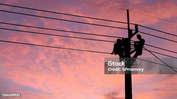Electrician Worker Climbing Electric Power Pole To Repair The Damaged Power Cable Line Problems After The Storm Power Line Supporttechnology Maintenance And Development Industry Concept Stock Photo - Download Image Now