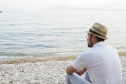 Pensive man at the beach