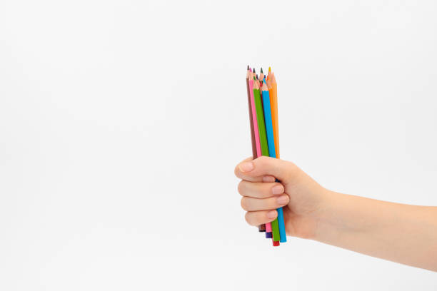 istock Multi-colored pencils for drawing in a female hand. 1264272228