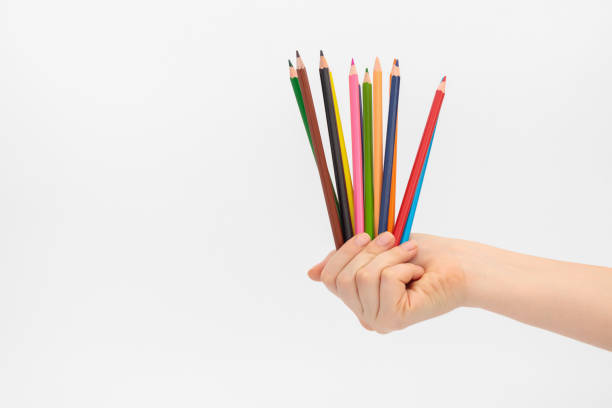 istock Multi-colored pencils for drawing in a female hand. 1264272229