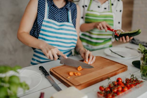 istock Young women preparing food in the kitchen 1264279081