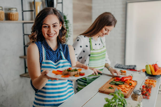 istock Young women preparing food in the kitchen 1264279187