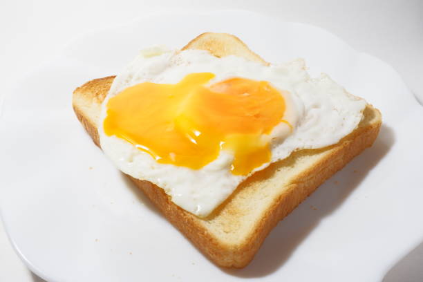 istock bread topped with a sunny-side up egg with a broken yolk 1264279352