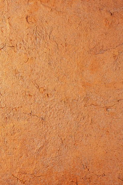 istock Abstract terracotta rustic orange textured background with lots of cracks and character. 1264279434