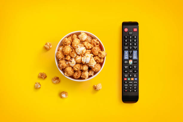 istock Popcorn in cardboard box and tv remote control 1264280392