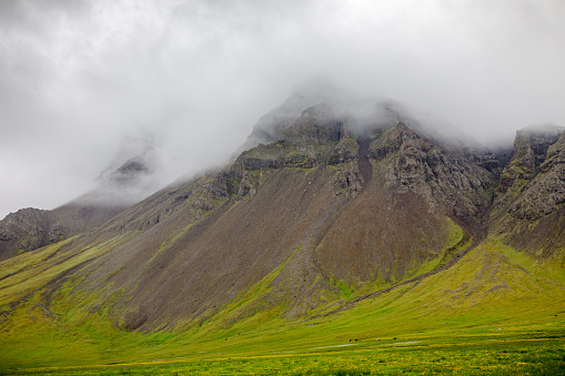 Clouds covering a mountain top in the changing weather of Iceland