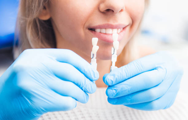 istock Closeup of dentist holding dentures 1264283020