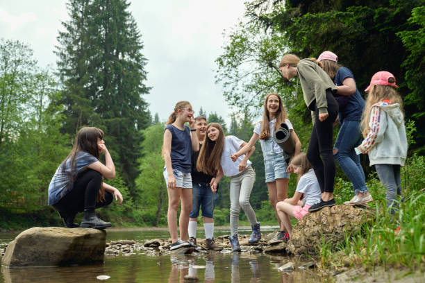 istock Teenage friends having fun on river beach. 1264286712