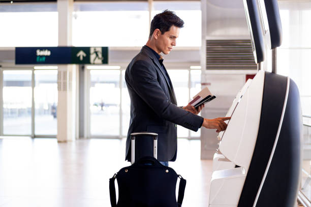 istock Businessman at an airport checking in. 1264288288