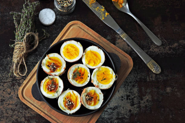 istock Soft-boiled eggs in the shell in a small skillet. 1264289029