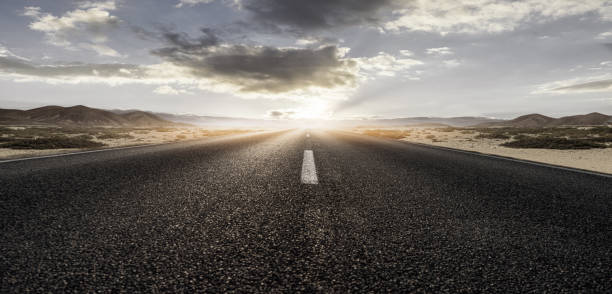 istock Road leads into the sunset 1264289563