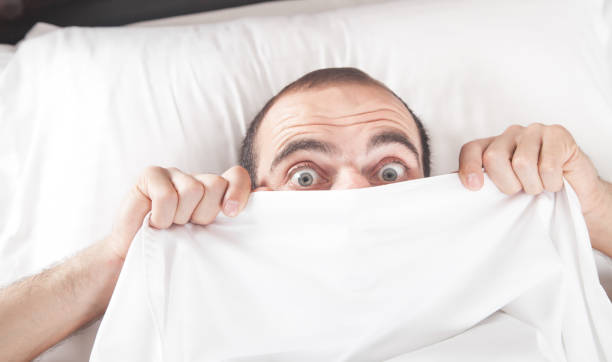 istock Caucasian surprised man in bed. 1264290281