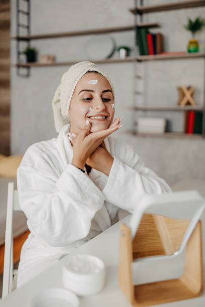 istock Young girl applying face cream 1264290458