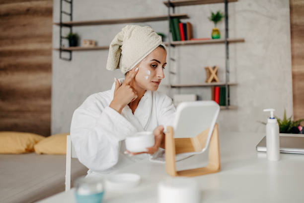 istock Young girl applying face cream 1264291729