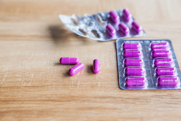 istock Capsules and medication on wooden table 1264291786