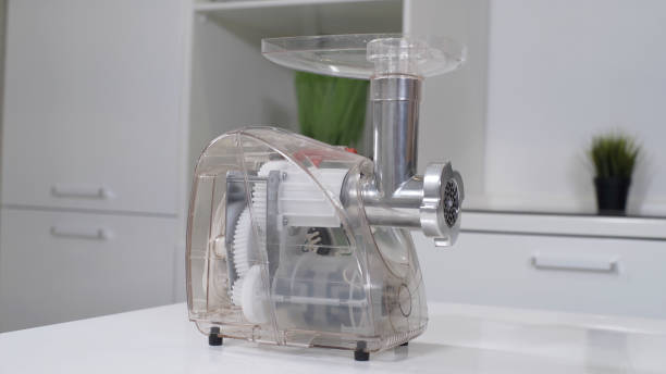 istock Transparent plastic meat grinder for minced meat per minute, make sausages, mashed berries, squeeze juice and chop vegetables. Meat mincer of increased power is reliable assistant in kitchen. 1264295216