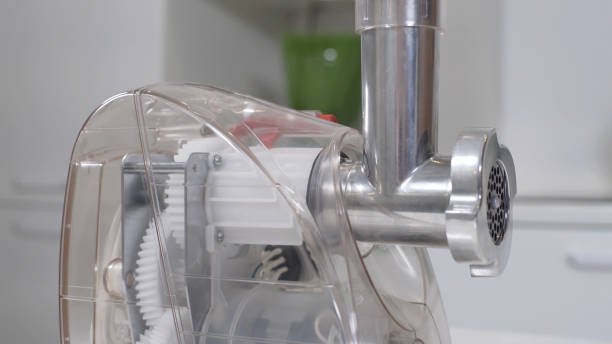 istock Transparent plastic meat grinder for minced meat per minute, make sausages, mashed berries, squeeze juice and chop vegetables. All parts of the meat grinder are visible. 1264295240
