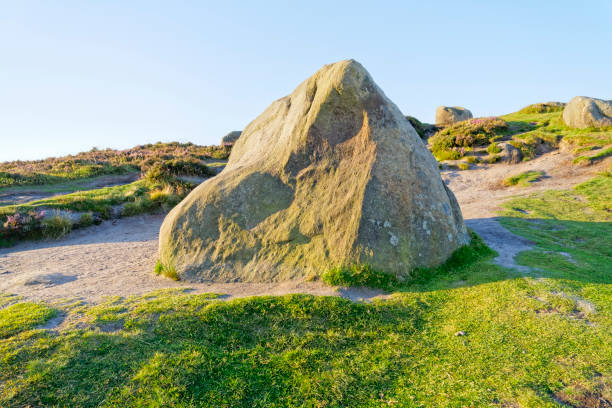 istock Large multicoloured Derbyshire gritstone rock in the early morning sunlight 1264295403