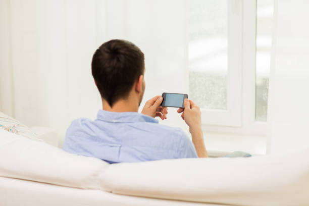 istock close up of man with smartphone at home 1264295437