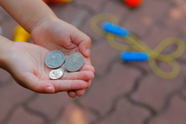 istock image of children hand coin 1264297493