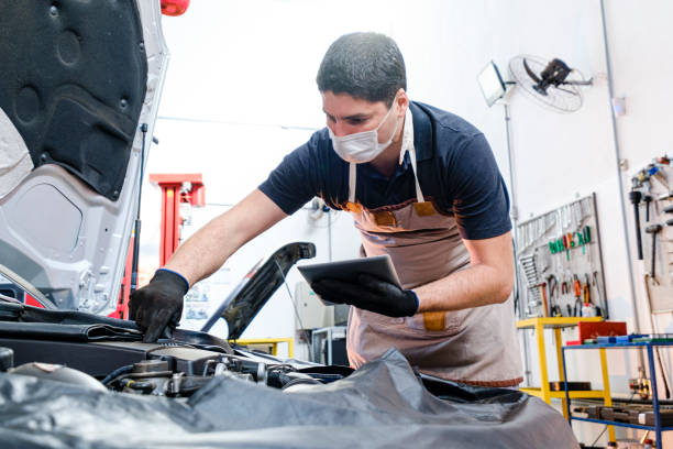 istock Mechanic with tablet performing automotive check 1264299057
