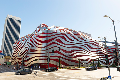 Los Angeles, California, United States - October 20, 2019: The Petersen Automotive Museum after the 2015 renovation and redesign by the architectural firm Kohn Petersen Fox, along with people, cars, and buildings in California - United States