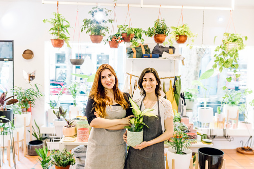 Two Women working in a flower shop. Portraits