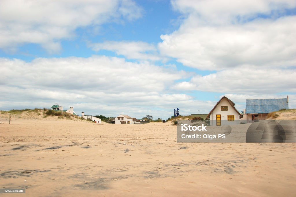 Vallizas is a beach town in Uruguay on the shores of the sea. Vallizas is a beach town in Uruguay on the shores of the sea. A beach white old houses in the sand on the ocean. Fisherman and artisans village. Tranquility and peaceful destination. Uruguay Stock Photo
