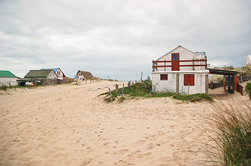 Beach town in Uruguay on the shores of the sea. A beach white house in the sand on the ocean. Fisherman and artisans. Tranquility and peaceful destination village
