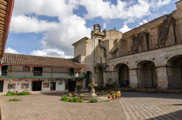 Inside a courtyard of a church Inside a courtyard of a church in the north of Peru with a fountain and a bell peru city stock pictures, royalty-free photos & images