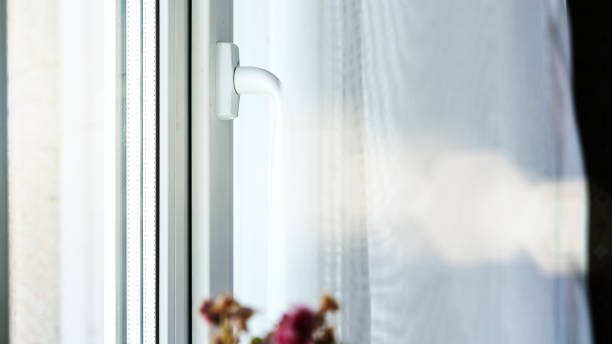 istock white curtains on plastic window and pot flower top closeup 1264309371