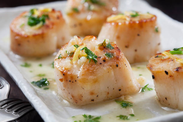 Scallops Poached in a Garlic Butter Sauce with Parsley and Lemon Zest