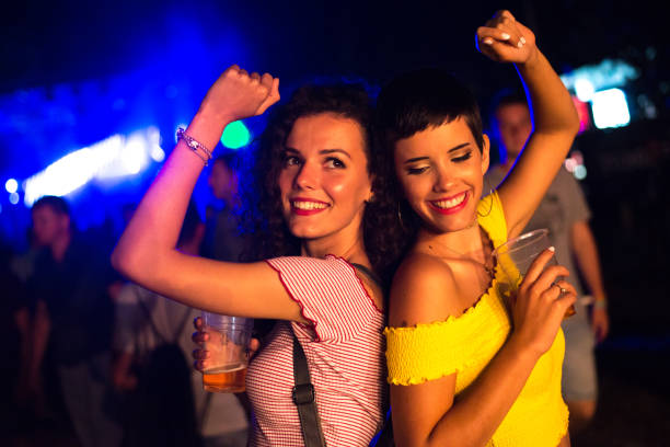 istock Young women drinking and dancing 1264309786