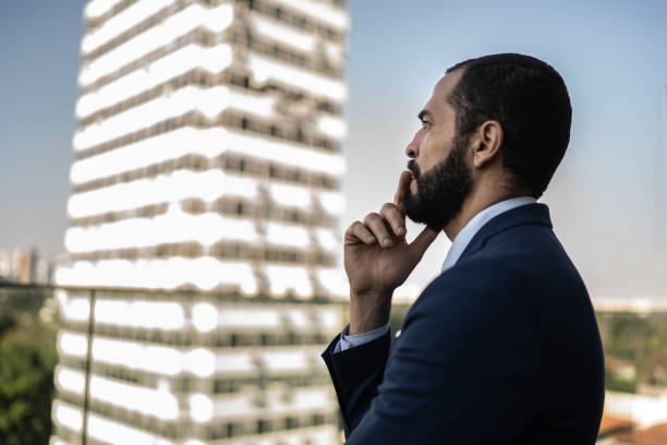 istock Thoughtful businessman looking away 1264312815
